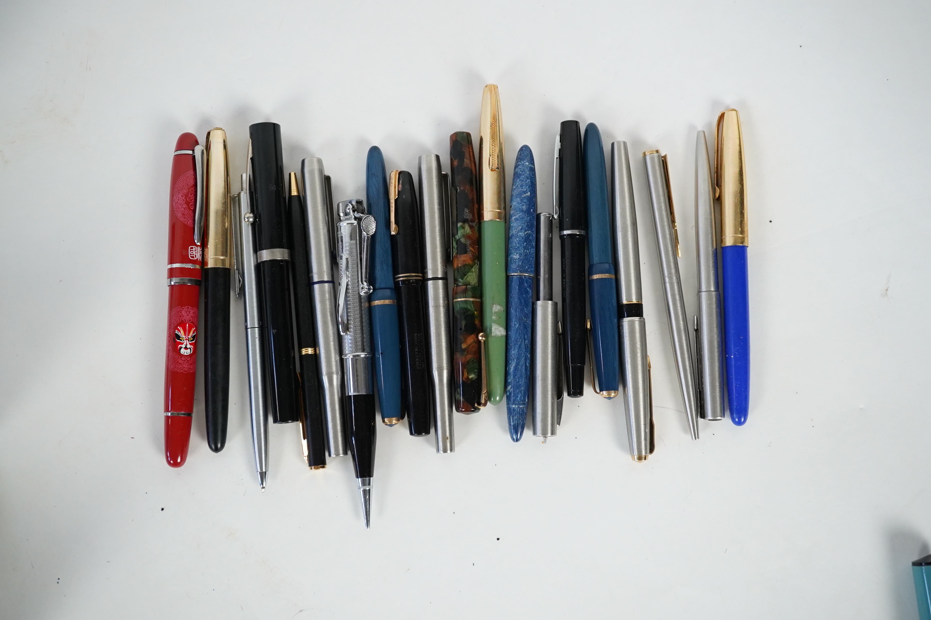 A cased Parker duofold ballpoint pen, a cased Parker Sonnet lacquer ruby red fountain pen, a Dunhill gold plated fountain pen and various fountain pens and ballpoint pens including Parker, Sheaffer, Quill, etc.